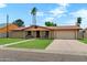 Charming single-story home with a well-manicured lawn and a two-car garage at 4333 E Desert Cactus St, Phoenix, AZ 85032