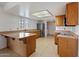 Spacious kitchen with warm wood cabinets, tile floors and stainless steel appliances at 4333 E Desert Cactus St, Phoenix, AZ 85032