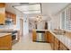 Kitchen with stainless steel appliances, wood cabinets and tile flooring at 4333 E Desert Cactus St, Phoenix, AZ 85032