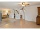 Spacious living room with carpet and tile flooring featuring a ceiling fan at 4333 E Desert Cactus St, Phoenix, AZ 85032