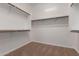 Spacious walk-in closet with ample hanging space and neutral carpet at 44574 W Garden Ln, Maricopa, AZ 85139