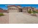Inviting home with a spacious driveway, two-car garage, and additional one-car garage at 44574 W Garden Ln, Maricopa, AZ 85139