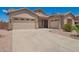 Inviting home with a spacious driveway, two-car garage, and additional one-car garage at 44574 W Garden Ln, Maricopa, AZ 85139