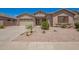 Charming single-story home featuring a low-maintenance desert landscape and a two-car garage at 44574 W Garden Ln, Maricopa, AZ 85139