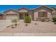 Attractive single-Gathering home showcasing a well-maintained yard with desert landscaping and decorative shutters at 44574 W Garden Ln, Maricopa, AZ 85139