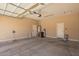 Garage features concrete flooring, water heater, garage door and plenty of space at 44574 W Garden Ln, Maricopa, AZ 85139