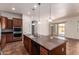 Kitchen island with granite counters, pendant lights, and modern stainless appliances at 44574 W Garden Ln, Maricopa, AZ 85139