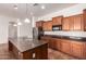 Well-equipped kitchen features granite counters, island and stainless steel appliances at 44574 W Garden Ln, Maricopa, AZ 85139