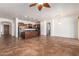 Open layout showcases kitchen with island, stainless appliances, and tile flooring at 44574 W Garden Ln, Maricopa, AZ 85139