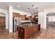 Modern kitchen featuring an island, stainless appliances, and tile floors at 44574 W Garden Ln, Maricopa, AZ 85139