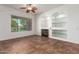Cozy living room featuring a fireplace, built-in shelves, and tile floors at 44574 W Garden Ln, Maricopa, AZ 85139