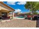 Expansive backyard oasis boasting a pool, spa, covered patio, and ample seating, ideal for outdoor living and social gatherings at 455 W Honeysuckle Dr, Chandler, AZ 85248