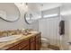 Well-lit bathroom featuring double sinks, granite countertops, and a neutral color palette, offering a clean and modern aesthetic at 455 W Honeysuckle Dr, Chandler, AZ 85248