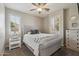 Bright bedroom with plantation shutters, ceiling fan, and comfortable gray decor at 455 W Honeysuckle Dr, Chandler, AZ 85248