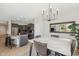 Elegant dining area with marble table, modern chandelier, and seamless access to the kitchen at 455 W Honeysuckle Dr, Chandler, AZ 85248