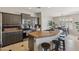 Modern kitchen with granite countertops, stainless steel appliances, and an island with bar seating at 455 W Honeysuckle Dr, Chandler, AZ 85248