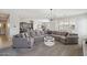 Spacious living room features an oversized sofa, neutral carpet, and lots of natural light at 455 W Honeysuckle Dr, Chandler, AZ 85248