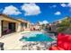 Relaxing backyard pool with patio furniture, lush landscaping, and sunny skies create a private oasis at 455 W Honeysuckle Dr, Chandler, AZ 85248