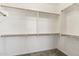 A clean and well-organized walk-in closet with wooden shelves and ample storage space at 455 W Honeysuckle Dr, Chandler, AZ 85248