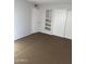 A bright bedroom featuring built-in shelving and closet space at 4628 E Wood St, Phoenix, AZ 85040