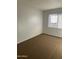 A cozy bedroom featuring plush carpeting and a window with bright natural light at 4628 E Wood St, Phoenix, AZ 85040