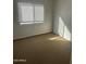 A bedroom with a bright window and carpeted flooring at 4628 E Wood St, Phoenix, AZ 85040