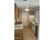 Functional kitchen with appliances, ample cabinet space, and tile flooring at 4628 E Wood St, Phoenix, AZ 85040
