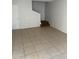 Bright living room featuring tile flooring, stairs, and neutral walls, a perfect blank canvas at 4628 E Wood St, Phoenix, AZ 85040