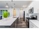 Bright kitchen featuring white cabinets, stainless steel appliances, and a spacious island with modern lighting at 476 S Soho Ln # 2, Chandler, AZ 85225