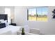 Bright bedroom with a view, white trim, and seating arrangement providing a cozy retreat at 488 S Soho Ln # 4, Chandler, AZ 85225