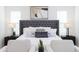 Bright bedroom with tufted headboard, neutral armchairs, and stylish lamps for a serene retreat at 488 S Soho Ln # 4, Chandler, AZ 85225