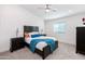 Bright bedroom features a modern black headboard, stylish lighting, and fresh white walls at 494 S Soho Ln # 5, Chandler, AZ 85225