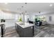 Modern kitchen with stainless steel appliances, a large island, and an open concept design to the living room at 505 S Soho Ln # 30, Chandler, AZ 85225