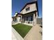 Inviting two-story home featuring a well-maintained lawn and cozy outdoor seating area at 511 S Soho Ln # 29, Chandler, AZ 85225