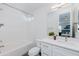 A stylish bathroom features a combination bathtub and shower and a white vanity with chrome fixtures at 512 S Soho Ln # 8, Chandler, AZ 85225