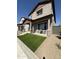 Charming two-story home featuring a cozy front porch with artificial grass and beautiful stone pillar accents at 512 S Soho Ln # 8, Chandler, AZ 85225