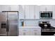 Close up on a modern kitchen featuring stainless steel appliances, white countertops, and sleek backsplash at 512 S Soho Ln # 8, Chandler, AZ 85225