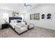 Spacious main bedroom featuring a ceiling fan, neutral decor, and sitting area, creating a relaxing retreat at 512 S Soho Ln # 8, Chandler, AZ 85225