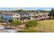 Row of modern two-story homes, showcasing a community-oriented design, landscaping, and mountain views at 512 S Soho Ln # 8, Chandler, AZ 85225