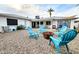 Relaxing backyard featuring a fire pit surrounded by blue chairs, perfect for gathering and enjoying the outdoors at 5309 W Dahlia Dr, Glendale, AZ 85304