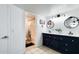 Bathroom with double sinks, modern vanity, and a bathtub with a shower at 5309 W Dahlia Dr, Glendale, AZ 85304