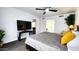 Cozy bedroom featuring neutral tones and ceiling fan, with adjoining bathroom at 5309 W Dahlia Dr, Glendale, AZ 85304