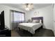 Bright bedroom featuring a ceiling fan, cozy bed, and natural light from the window at 5309 W Dahlia Dr, Glendale, AZ 85304
