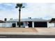 Charming single-story home with a well-manicured yard, palm tree, and American flag, showcasing curb appeal at 5309 W Dahlia Dr, Glendale, AZ 85304