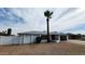 Single-story house with palm tree and American flag in the front yard, creating a welcoming and patriotic ambiance at 5309 W Dahlia Dr, Glendale, AZ 85304