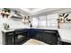 Kitchen with stainless steel appliances, black cabinets, white countertops, and ample natural light at 5309 W Dahlia Dr, Glendale, AZ 85304