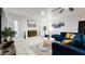 Bright living room with white brick fireplace, modern decor, and comfortable blue sofa at 5309 W Dahlia Dr, Glendale, AZ 85304
