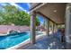 Covered patio overlooking a pristine pool with waterfall feature, perfect for outdoor relaxation and entertaining at 6030 W Topeka Dr, Glendale, AZ 85308