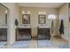 Bathroom with dual vanities, framed mirrors, modern lighting, and tile flooring at 6030 W Topeka Dr, Glendale, AZ 85308