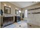 Bright bathroom featuring dual vanities, framed mirrors, tile flooring, and a shower with glass block window at 6030 W Topeka Dr, Glendale, AZ 85308